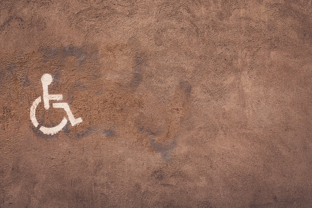 Brown wall with a white handicap symbol